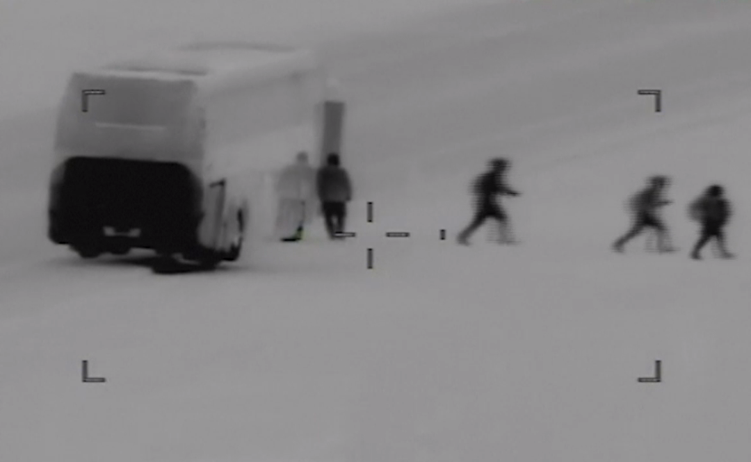 New video shows dozens of migrants crawling under a fence and entering the U.S.